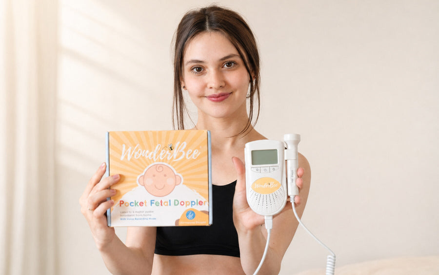 Expectant parent holding the WonderBee Classic Pocket Fetal Doppler and its branded box